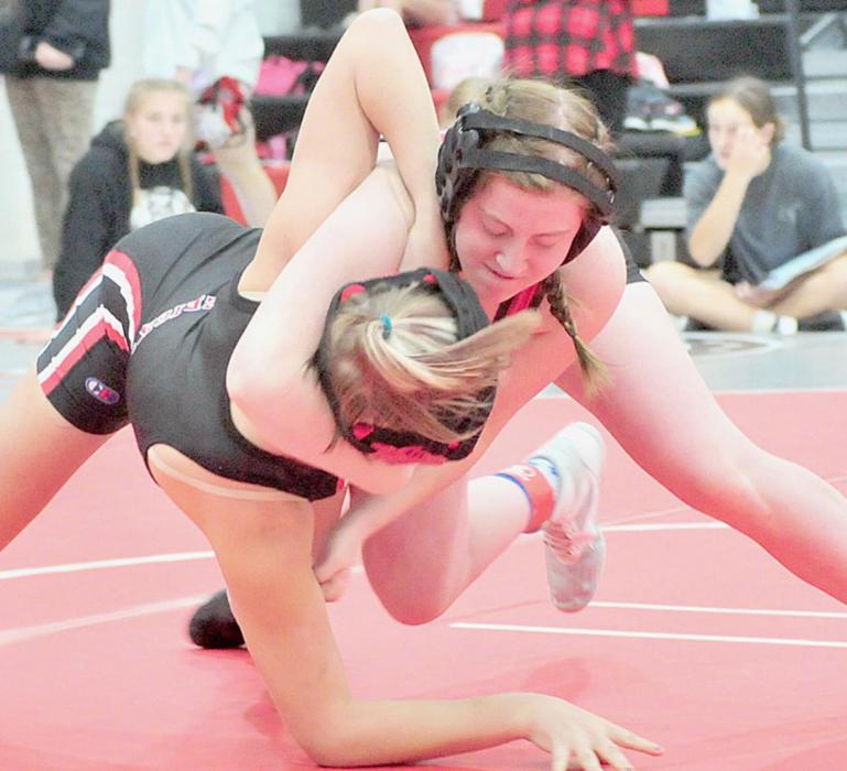 Wrestling in the 120 lb. weight class at the Amherst Invitational Wrestling Tournament, Tatum Nickless goes for a take down.