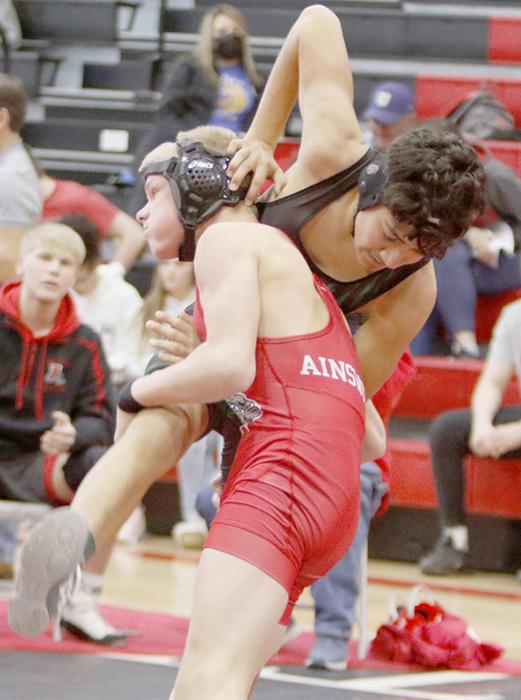 Mason Painter goes for a take down in the 120 lb. weight class at the Ainsworth Invitational Wrestling Tournament.
