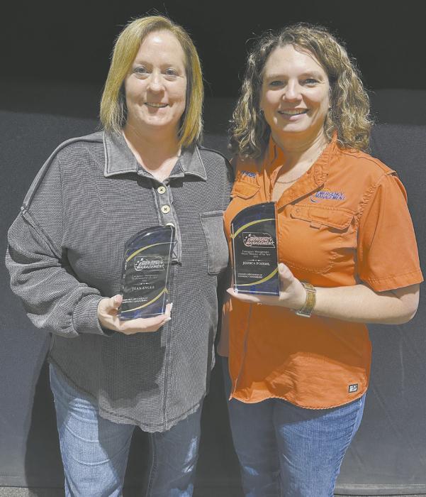Jean Engle (left) and Jessica Pozehl (right) stand with their awards from the Nebraska Association of Emergency Managment Nebraska Association.