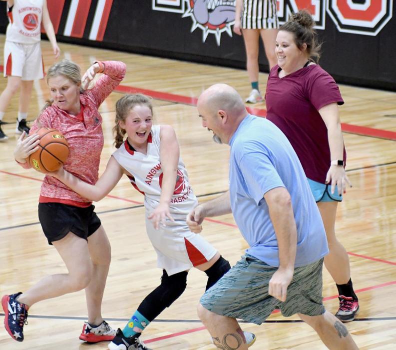 Left to Right: ACS Teacher Jessica Kempcke steals the ball from 7th Grader Kinsey Walz after Kempcke and staff members Jake Nelson and Melissa Freudenburg trap her.
