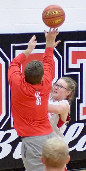 Jessi Owen tries to shoot a layup over tough 8th Grade defender Gracyn Painter.