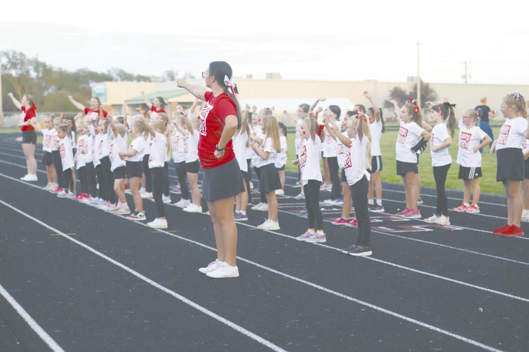 Junior Madison Palmer cheers alongside the Little Dawg Cheerleaders during Friday’s game.