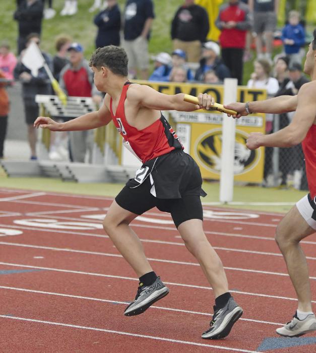 Junior Christopher Fernandez hands the baton to freshman Zaine Evans during the 4x400 meter relay. The team of Owen Blumenstock, Christopher Fernandez, Zaine Evans, and Jacob Ortner placed 12th, running a time of 3:38.77.
