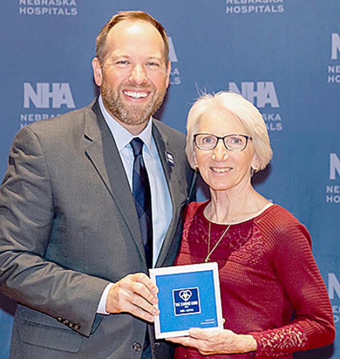Jeannie Welke (Right) received the Caring Kind Award from NHA President Jeremy Nordquist, MPA, (Left).